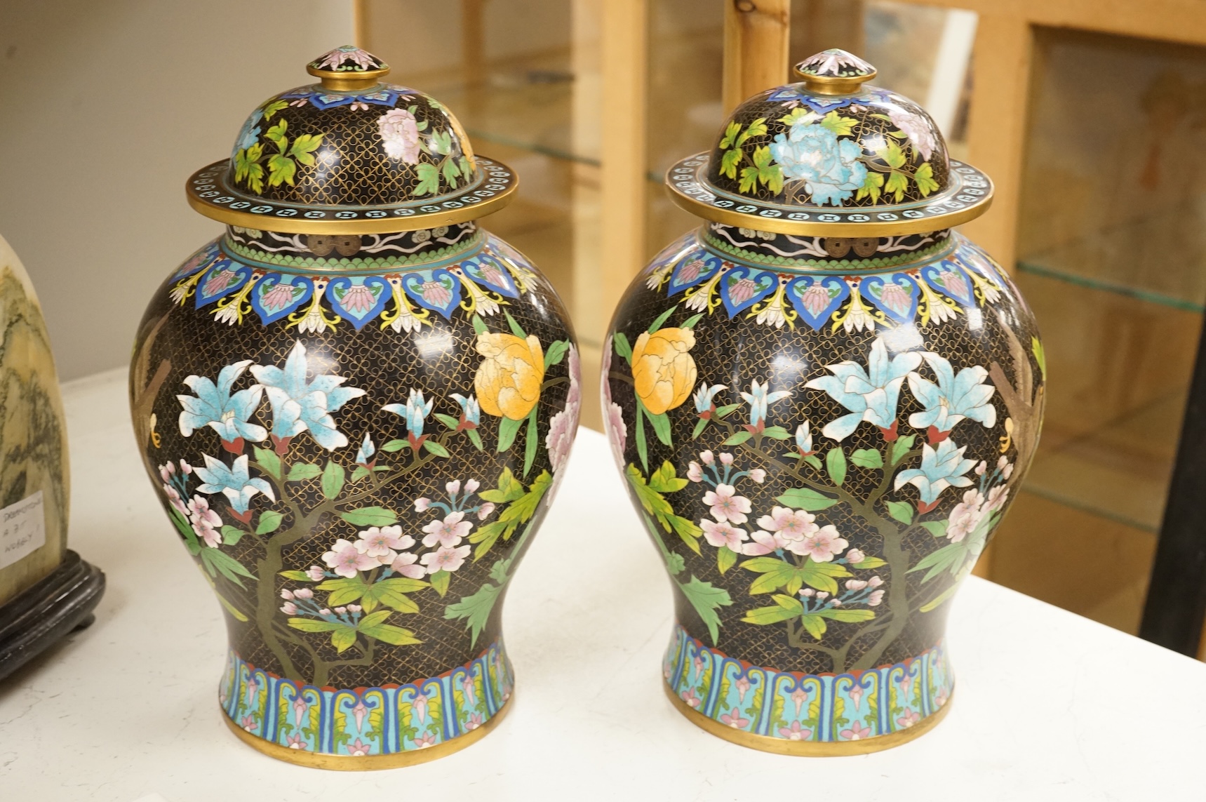 A pair of Chinese cloisonné baluster jars and covers decorated with birds and flowers, 38cm high